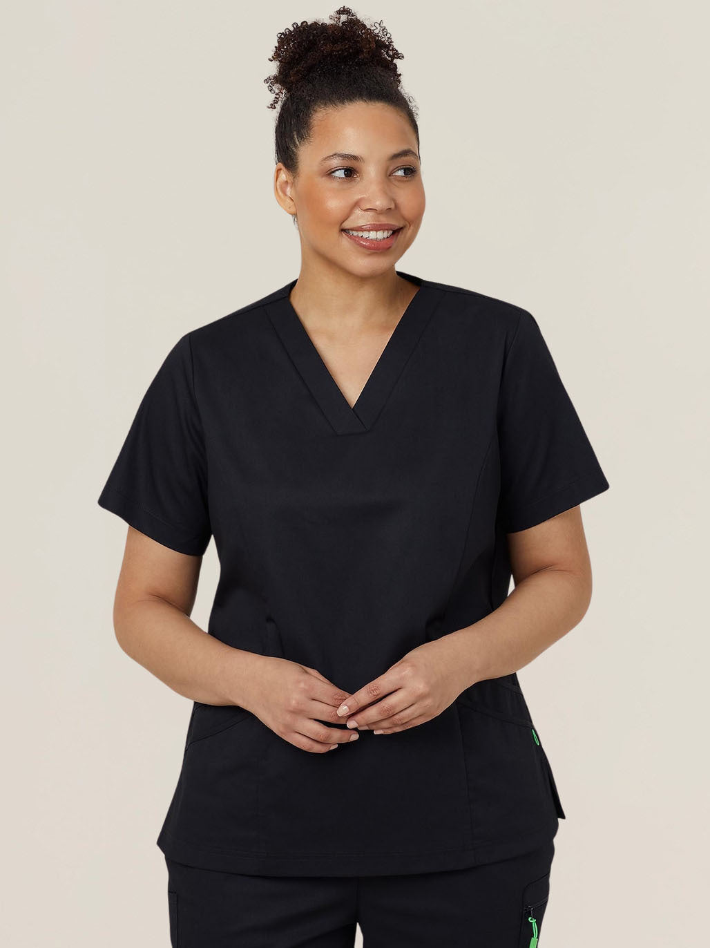 A woman wearing black scrubs.