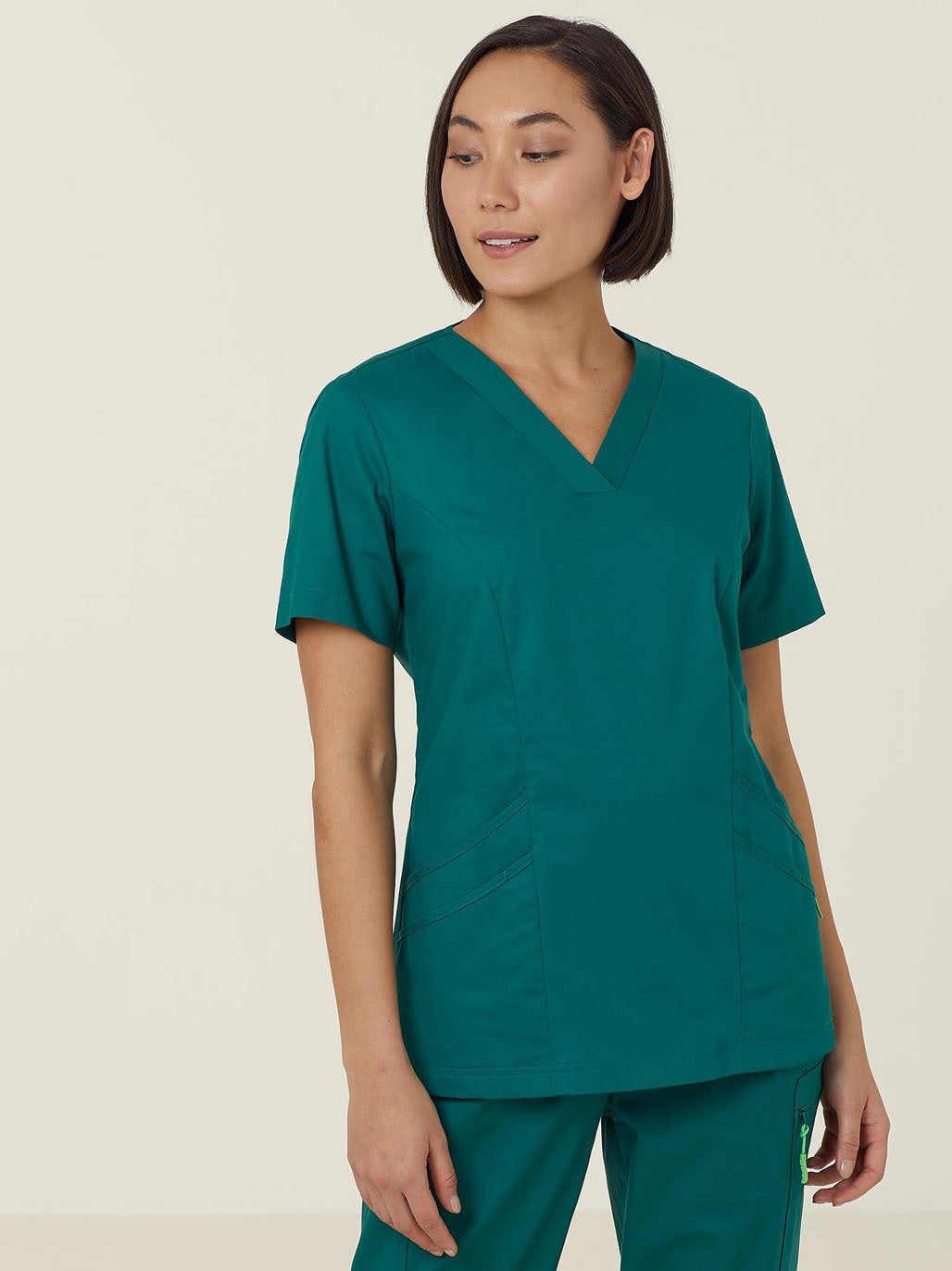 Woman in teal scrub top.