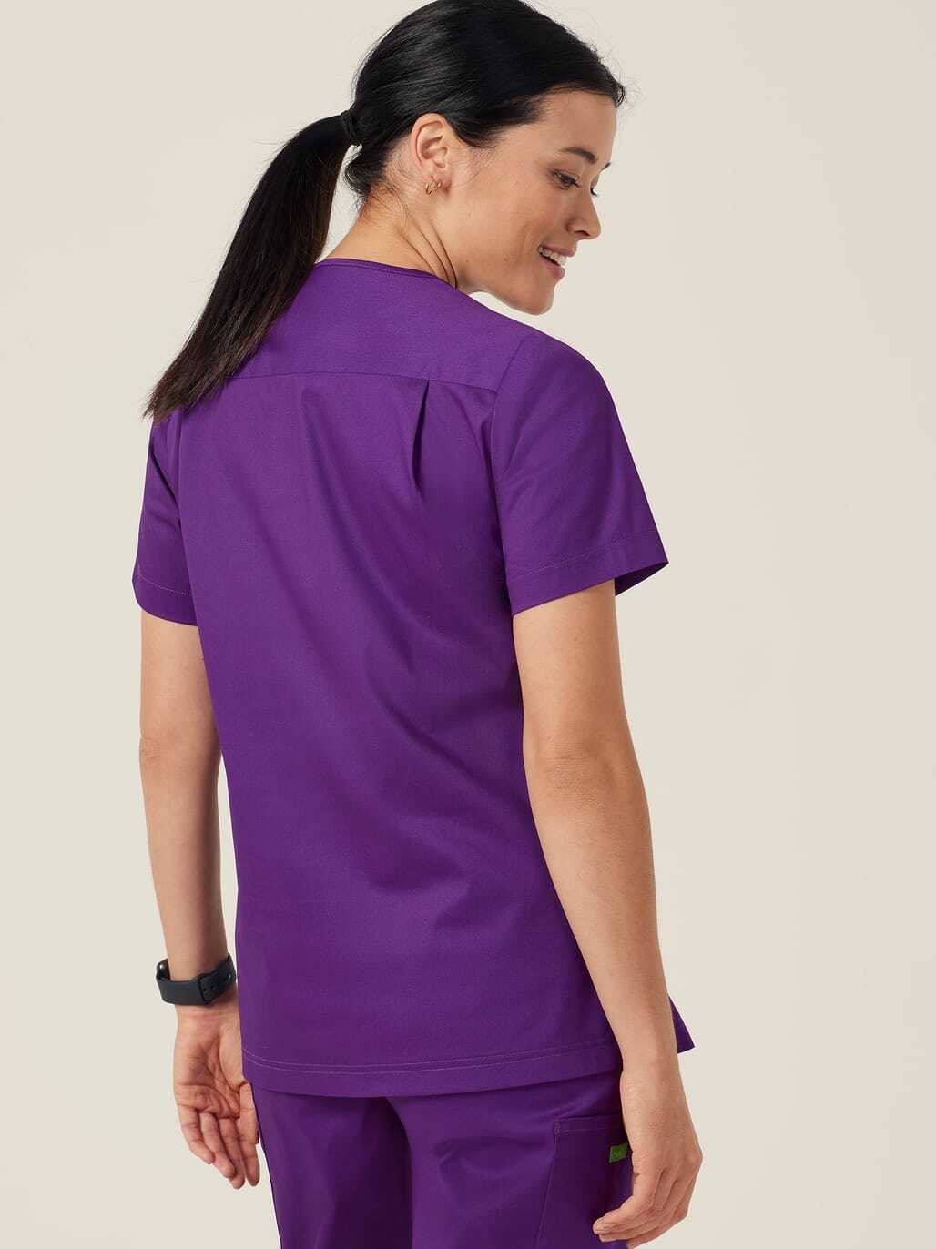 Woman wearing purple scrubs.